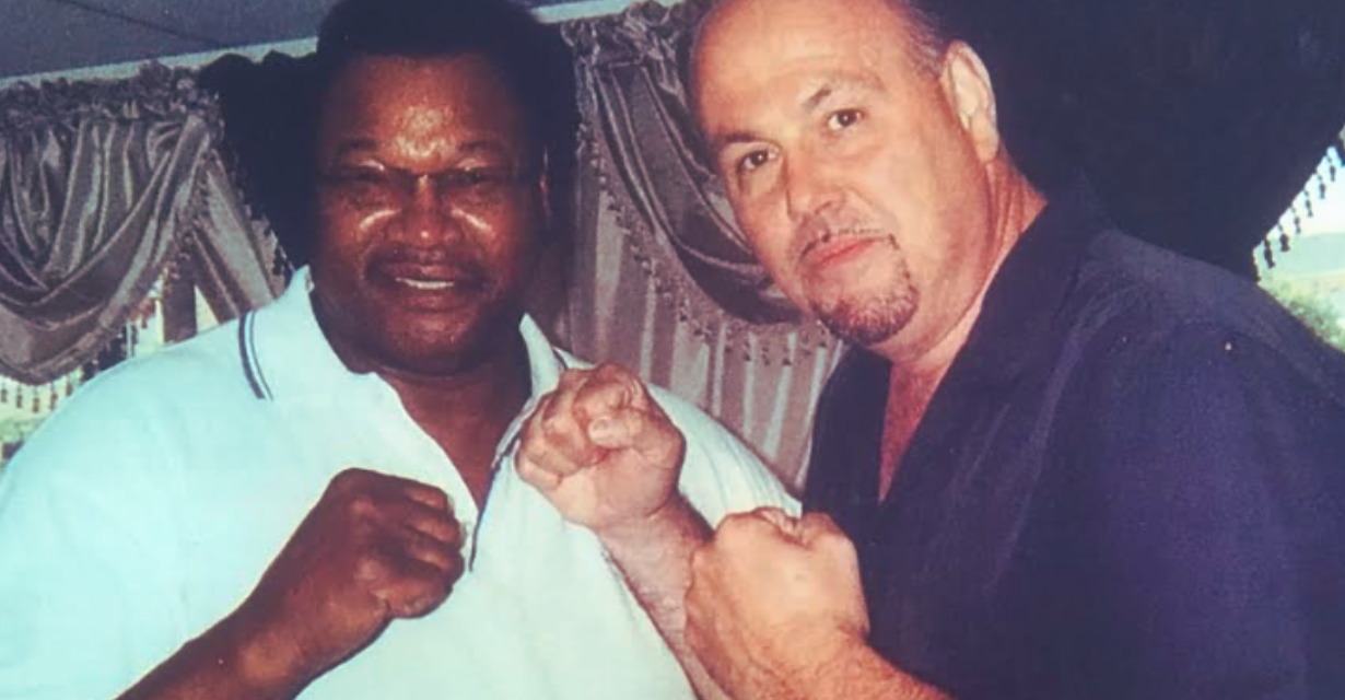 jay dehmalo and george foreman posing boxing